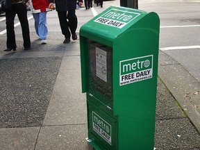 In this file photo, a Metro free daily newspaper box sits on a sidewalk.