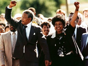 FILE - In this file photo dated Sunday, February 11, 1990, Nelson Mandela and wife Winnie, walk hand in hand, raising their clenched fists upon his release from Victor prison, Cape Town, 27 years in detention. South African state broadcaster SABC said Monday April 2, 2018, that anti-apartheid activist Winnie Madikizela-Mandela has died. (AP Photo)