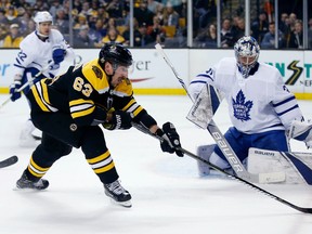 Bruins forward Brad Marchand tries to get a handle on the puck in front of Maple Leafs goalie Frederik Andersen on Saturday night in Boston. (The Associated Press)