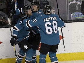 Sharks left wing Marcus Sorensen, centre, is congratulated by defenceman Paul Martin (7) and right wing Melker Karlsson (68) after scoring against the Ducks during Game 4 of their first-round NHL playoff series in San Jose, Calif., Wednesday, April 18, 2018. (Jeff Chiu/AP Photo)