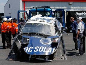 Crew members and NASCAR officals work on the car of Jamie McMurray after an on-track incident during practice for the Monster Energy NASCAR Cup Series GEICO 500 at Talladega Superspeedway on April 27, 2018 in Talladega, Alabama. (Brian Lawdermilk/Getty Images)