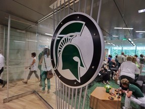 In this Aug. 25, 2014, file photo, people tour the new North End Zone Complex renovations at Spartan Stadium on the Michigan State Campus in East Lansing, Mich.