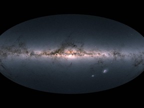 A handout photo released on April 25, 2018 by the European Space Agency shows Gaia's all-sky view of our Milky Way Galaxy and neighbouring galaxies, based on measurements of nearly 1.7 billion stars.  The map shows the total brightness and colour of stars observed by the ESA satellite in each portion of the sky between July 2014 and May 2016. Brighter regions indicate denser concentrations of especially bright stars, while darker regions correspond to patches of the sky where fewer bright stars are observed. The colour representation is obtained by combining the total amount of light with the amount of blue and red light recorded by Gaia in each patch of the sky. (AFP PHOTO/EUROPEAN SPACE AGENCY/GAIA /DPAC)