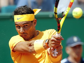 Spain's Rafael Nadal returns the ball to Bulgaria's Gregor Dimitrov during their semifinal singles match of the Monte Carlo Tennis Masters tournament in Monaco, Saturday April 21, 2018.