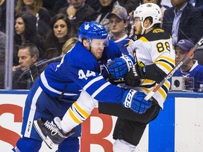 Toronto Maple Leafs defenceman Morgan Rielly hits Boston Bruins forward David Pastrnak at the Air Canada Centre in Toronto Monday, April 16, 2018. (Ernest Doroszuk/Toronto Sun)
