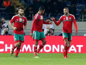 In this Jan. 13, 2018 file photo, Morocco's team celebrates after scoring against Mauritania during the CHAN opening group A soccer match in Casablanca, Morocco