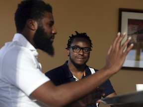 Rashon Nelson, left, speaks as Donte Robinson looks on during an interview with The Associated Press in Philadelphia on Wednesday, April 18, 2018. (Jacqueline Larma/AP Photo)