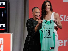 Connecticut's Kia Nurse, right, poses for a photo with WNBA President Lisa Borders after being selected as the 10th pick by the New York Liberty in the WNBA draft on April 12, 2018