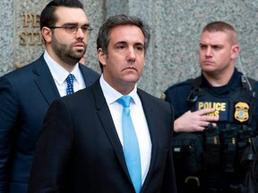 In a Monday, April 16, 2018, file photo, Michael Cohen, President Donald Trump's personal attorney, center, leaves federal court, in New York.