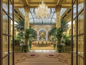 This undated photo provided by the Plaza in New York City shows the hotel's Palm Court, known for its elaborate afternoon teas. On May 19, the hotel is hosting a $150 Champagne breakfast in the Palm Court with livestreaming of the royal wedding of Prince Harry and Meghan Markle. Guests are encouraged to wear hats and gloves. It's one of a number of royal wedding-themed events being offered by hotels. (The Plaza via AP)