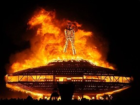 In this Aug. 31, 2013, file photo, the "Man" burns on the Black Rock Desert at Burning Man near Gerlach, Nev. Larry Harvey, the co-founder of the "Burning Man" festival has died. He was 70.