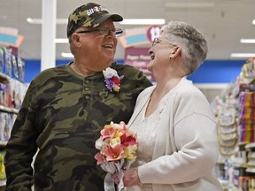 In this April 1, 2018 photo, Larry Spiering and Becky Smith smile where they held their wedding ceremony on Easter Sunday in aisle 13 of the Community Market in Lower Burrell, Pa.
