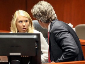 Brooke Skylar Richardson, left, an Ohio woman charged in the death of her newborn infant found buried outside her home, listens to her defence attorney Charles M. Rittgers during a pretrial hearing in Lebanon, Ohio, Aug. 15, 2017. (Greg Lynch/The Journal-News via AP)