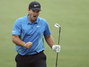 Patrick Reed celebrates his eagle chip on No. 15 during the third round of the Masters golf tournament Saturday, April 7, 2018, at Augusta National in Augusta, Ga. (Jason Getz/Atlanta Journal-Constitution via AP)