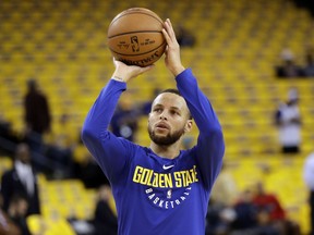 Golden State Warriors' Stephen Curry shoots during warmups before Game 1 of an NBA basketball second-round playoff series against the New Orleans Pelicans, Saturday, April 28, 2018, in Oakland, Calif.