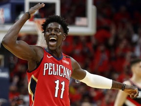 New Orleans Pelicans guard Jrue Holiday (11) celebrates after making a three-point basket during Game 4 against the Portland Trail Blazers in New Orleans, Saturday, April 21, 2018. (AP Photo/Scott Threlkeld)
