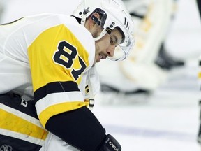 Penguins captain Sidney Crosby tightens the laces on his skates during warmups before facing the Flyers in Game 3 of their NHL playoff series in Philadelphia, Sunday, April 15, 2018. (Tom Mihalek/AP Photo)