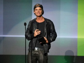 In this Nov. 24, 2013 file photo, Avicii accepts the award for favourite artist - electronic dance music at the American Music Awards in Los Angeles. Avicii's family released a statement Monday, April 23, 2018, saying they "would like to thank you for the support and the loving words about our son and brother." (John Shearer/Invision/AP/Files)