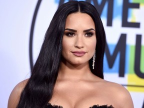 FILE - In this Nov. 19, 2017, file photo, Demi Lovato arrives at the American Music Awards at the Microsoft Theater in Los Angeles. Lovato ended the U.S. leg of her "Tell Me You Love Me" tour in a kiss with her opening act Kehlani. Kehlani sneaked on stage in Newark, N.J., on Monday, April 2, 2018, and grabbed Lovato, and the two shared a kiss.