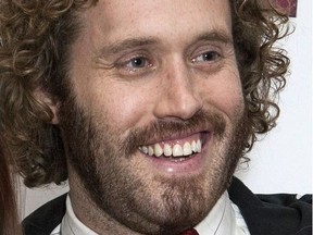 FILE - In this Jan. 28, 2016 file photo, actor TJ Miller poses for photos at a fan screening for the film "Deadpool," in central London. Miller was arrested Monday night, April 9, 2018, at LaGuardia Airport in New York and charged with calling 911 to falsely claim that a woman on the same train as him had a bomb in her luggage. Prosecutors said Miller called in the false bomb information on March 18 after getting into a verbal confrontation with a woman on a train traveling from Washington D.C. to New York. The train was stopped in Westport, Conn., where it was searched.