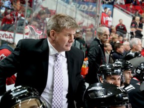 NOVEMBER 07: Bill Peters head coach of the Carolina Hurricanes wears a purple tie to honor Hockey Fights Cancer Night during their NHL game against the Columbus Blue Jackets at PNC Arena on November 7, 2014 in Raleigh, North Carolina. (Photo by Gregg Forwerck/NHLI via Getty Images)