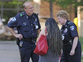 Law enforcement officers stand guard at the driveway entrance to the emergency room at Presbyterian Hospital in Dallas. on Tuesday, April 24, 2018. (Louis DeLuca/The Dallas Morning News via AP)