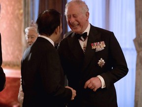 Britain's Prince Charles receives Sultan of Brunei Hassanal Bolkiah in the Blue Drawing Room for a drinks reception before The Queen's Dinner during The Commonwealth Heads of Government Meeting, at Buckingham Palace in London on April 19, 2018. (Matt Dunham/AFP/Getty Images)