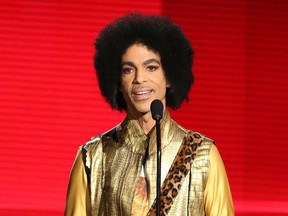 In this Nov. 22, 2015, file photo, Prince presents an award during the American Music Awards in Los Angeles.
