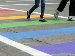 In this file photo, pedestrians walk across a rainbow-painted crosswalk in support of LGBT issues in London, Ont. on Wednesday June 29, 2016.