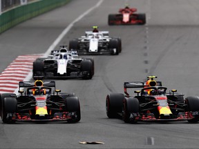 Max Verstappen of the Netherlands driving the (33) Aston Martin Red Bull Racing RB14 TAG Heuer and Daniel Ricciardo of Australia driving the (3) Aston Martin Red Bull Racing RB14 TAG Heuer battle on track  during the Azerbaijan Formula One Grand Prix at Baku City Circuit on April 29, 2018 in Baku, Azerbaijan.  (Mark Thompson/Getty Images)