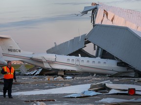 Authorities look over the damage caused by winds at an airplane hangar at William P. Hobby Airport Wednesday, April 4, 2018, in Houston.