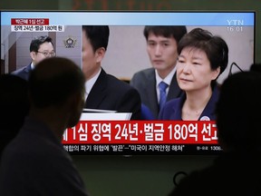 In this April 6, 2018 photo, people watch a TV screen showing file footage of former South Korean President Park Geun-hye during a news program at the Seoul Railway Station in Seoul, South Korea. North Korea has called disgraced former South Korean President Park Geun-hye a "traitor" responsible for "extra-large hideous corruption," in its first reaction to the sentencing of Park to 24 years in prison on corruption charges.