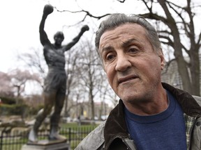 Sylvester Stallone talks to reports in front of the Rocky statue for a "Creed II" photo op, Friday, April 6, 2018, in Philadelphia.  (AP Photo/Michael Perez)