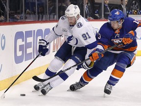 Tampa Bay Lightning centre Steven Stamkos (91) controls the puck against New York Islanders centre Mathew Barzal Thursday, March 22, 2018, in New York. (AP Photo/Julie Jacobson)