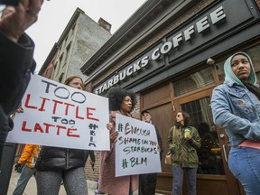 Protesters gather outside of a  Starbucks in Philadelphia, Sunday, April 15, 2018, where two black men were arrested Thursday after employees called police to say the men were trespassing. The arrest prompted accusations of racism on social media. Starbucks CEO Kevin Johnson posted a lengthy statement Saturday night, calling the situation "disheartening" and that it led to a "reprehensible" outcome.