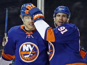 John Tavares of the New York Islanders congratulates Anders Lee on his goal against the Tampa Bay Lightning at the Barclays Center on March 22, 2018. (Bruce Bennett/Getty Images)