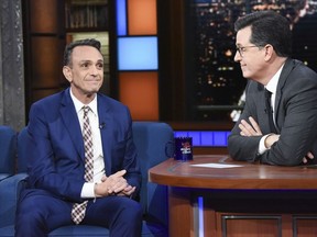 In this April 24, 2018 photo released by CBS, actor Hank Azaria, left appears with host Stephen Colbert on "The Late Show with Stephen Colbert," in New York. Azaria is ready to stop voicing Kwik-E-Mart owner Apu on "The Simpsons" in the wake of criticism that it is a stereotype. Azaria on Tuesday's "The Late Show with Stephen Colbert" says he hopes the animated show makes a change and he's willing to step aside if necessary.
