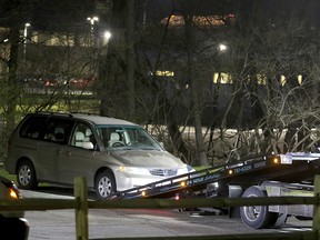 In this Tuesday, April 10, 2018 photo, a minivan is removed from the parking lot near the Seven Hills School campus in Cincinnati. (Cara Owsley/The Cincinnati Enquirer via AP)