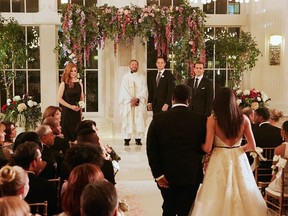 This image released by USA Network shows a wedding scene from the "Good-Bye" episode of "Suits." Meghan Markle's character dreams of getting married at the Plaza Hotel in New York City, though the scene was filmed at the Fairmont Royal York in Toronto. Both hotels are hosting royal-themed events in honor of Markle's wedding to Prince Harry.