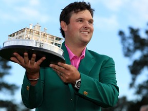 Patrick Reed of the United States celebrates with the trophy during the green jacket ceremony after winning the Masters at Augusta National Golf Club on April 8, 2018