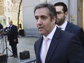 Michael Avenatti, Stormy Daniels' attorney, far left, watches as Michael Cohen, centre, U.S. President Donald Trump's personal attorney, leaves federal court in New York, Thursday, April 26, 2018. (Mary Altaffer/AP Photo)