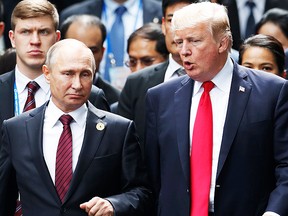 In this file photo taken on November 11, 2017 US President Donald Trump (R) and Russian President Vladimir Putin talk as they make their way to take the "family photo" during the Asia-Pacific Economic Cooperation (APEC) leaders' summit in the central Vietnamese city of Danang. (Getty Images)