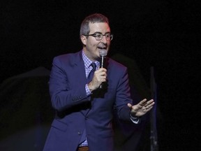 FILE - In this Nov. 7, 2017 file photo, comedian John Oliver performs at the 11th Annual Stand Up for Heroes benefit in New York. Oliver's show, which begins its fifth season on Sunday.