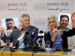 In this July 20, 2017, file photo, Marc and Debra Tice, the parents of Austin Tice, who has been missing in Syria since August 2012, hold up photos of him during a new conference, at the Press Club, in Beirut, Lebanon.