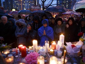 People pray for the victims of the mass killing at a vigil on April 24, 2018.