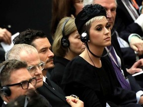 Katy Perry, right, flanked by Orlando Bloom, center, attend an audience by Pope Francis for the participants in the "United to Cure" international conference on the cure for cancer in the Paul VI hall, at the Vatican, Saturday, April 28, 2018.
