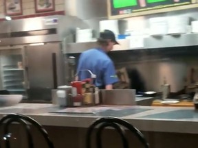 Jacinda Mitchell posted a video of her pulling on the locked door of a Waffle House restaurant in Pinson, Ala., while others dined. (Facebook)