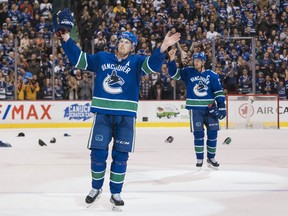 Daniel Sedin and Henrik Sedin of the Vancouver Canucks salute the fans after playing in their final home game of their career against the Arizona Coyotes in NHL action on April, 5, 2018