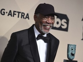 FILE - In this Jan. 21, 2018, file photo, Morgan Freeman poses with his Life Achievement Award in the press room at the 24th annual Screen Actors Guild Awards at the Shrine Auditorium & Expo Hall in Los Angeles. Selena Gomez, Lily Collins, Freeman and Jennifer Aniston will be among the stars at WE Day California, a youth empowerment event in Southern California on April 19, 2018.