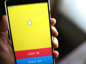 The Snapchat log-in page is displayed on a mobile phone.